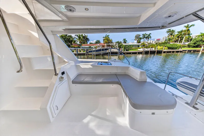 Slide: The Image of 2018 Leopard 51 Powercat yacht interior with seating area and water view. - 36