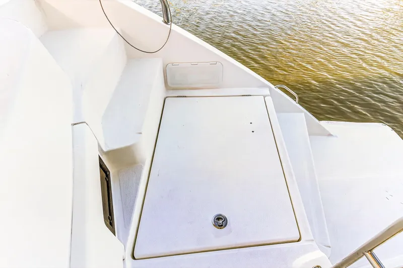 Slide: The Image of 2018 Leopard 51 Powercat deck view with storage compartment, near water. - 37