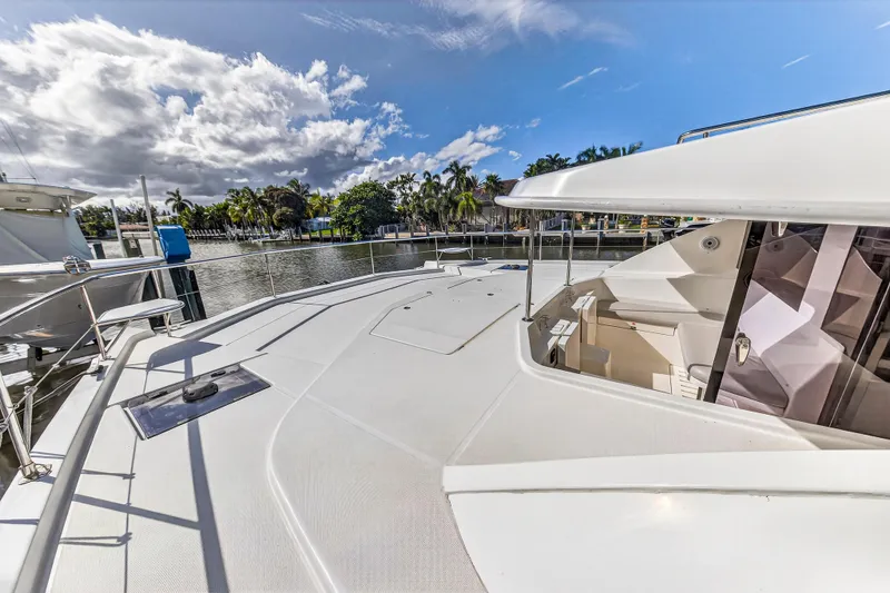 Slide: The Image of 2018 Leopard 51 Powercat yacht deck with clear skies and waterfront view. - 45