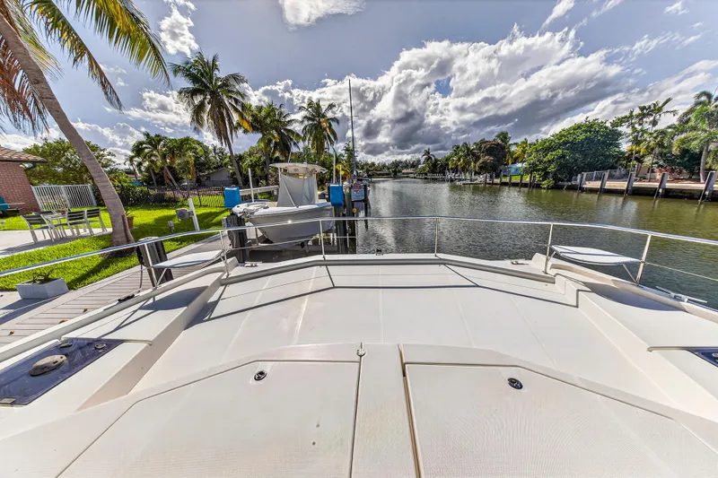 Slide: The Image of 2018 Leopard 51 Powercat docked by a scenic canal with palm trees and blue sky. - 47