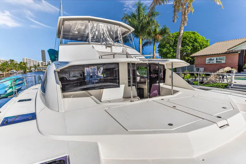 Slide: The Image of 2018 Leopard 51 Powercat yacht docked, featuring spacious deck and modern design. - 48