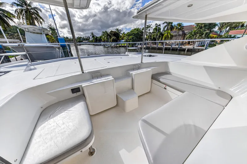 Slide: The Image of 2018 Leopard 51 Powercat deck with seating, surrounded by tropical scenery and waterway. - 56
