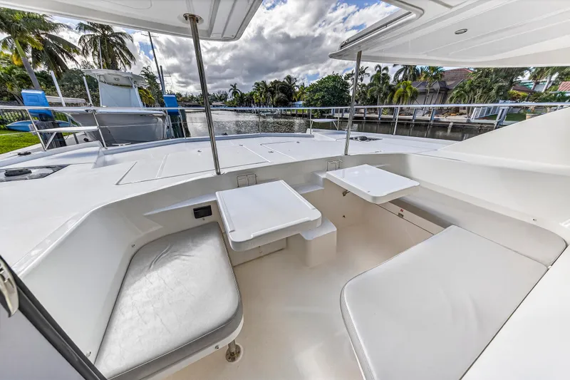 Slide: The Image of Spacious deck area of 2018 Leopard 51 Powercat with seating and tables, surrounded by waterway. - 57