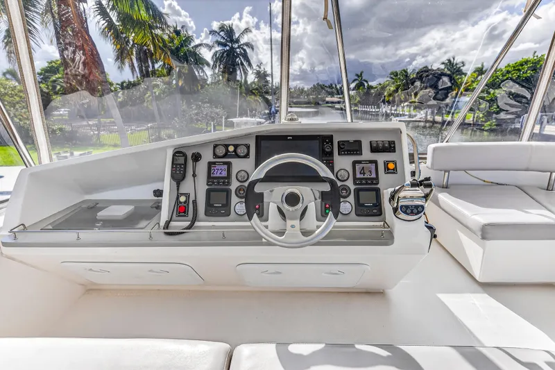 Slide: The Image of Helm of 2018 Leopard 51 Powercat with modern controls and tropical backdrop. - 59