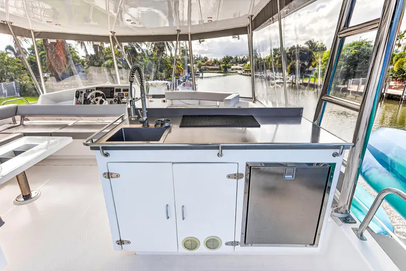 Slide: The Image of 2018 Leopard 51 Powercat yacht interior with modern kitchen and scenic waterway view. - 65