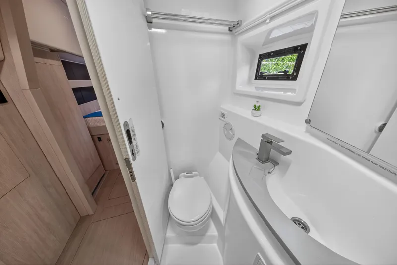 Slide: The Image of Compact bathroom in 2018 Leopard 51 Powercat with modern fixtures and small window. - 91
