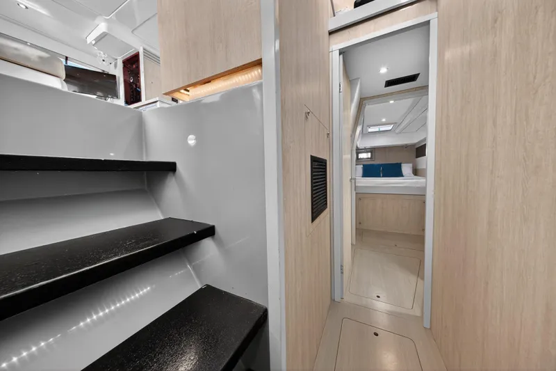 Slide: The Image of Interior of 2018 Leopard 51 Powercat, featuring modern stairs and cozy cabin entrance. - 93