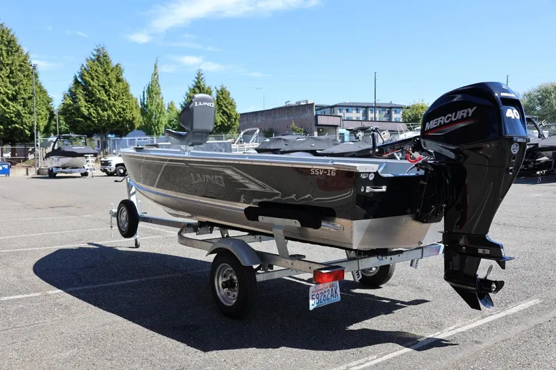 Slide: The Image of 2025 Lund SSV-18 boat with Mercury engine on a trailer in a parking lot. - 10