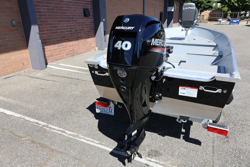 Slide: The Image of 2025 Lund SSV-18 boat with Mercury 40 outboard motor in parking lot. - 13