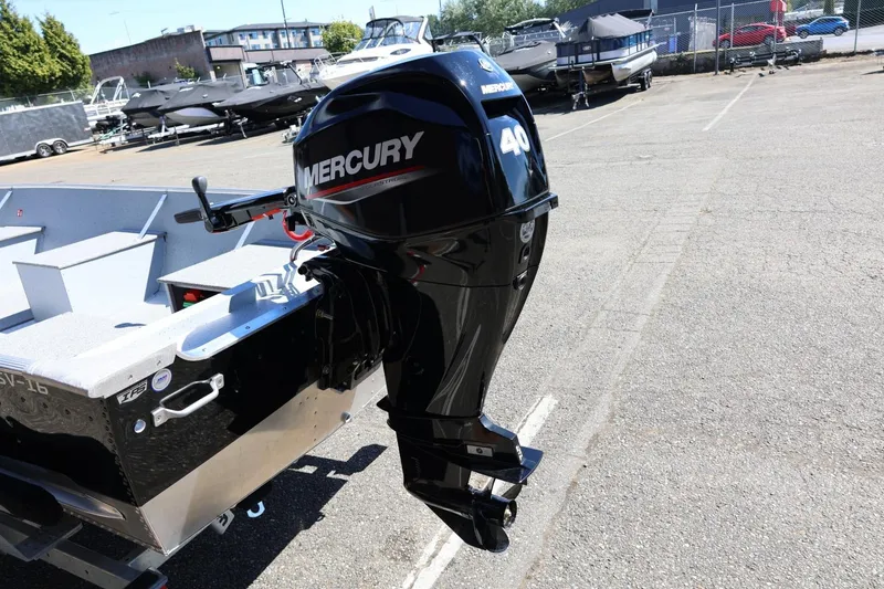 Slide: The Image of 2025 Lund SSV-18 boat with Mercury 40 outboard motor in a marina setting. - 14