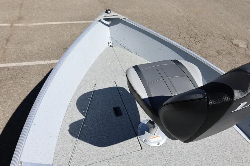 Slide: The Image of 2025 Lund SSV-18 boat interior with a single gray seat on a textured deck. - 20