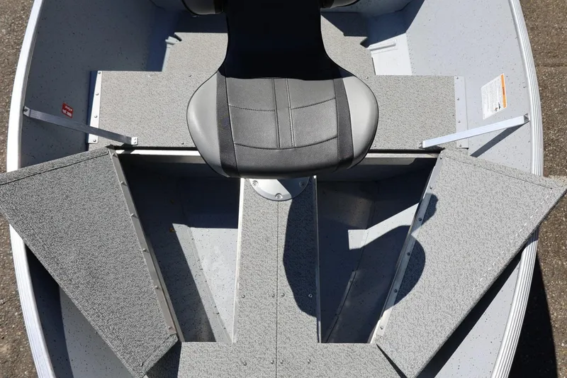 Slide: The Image of 2025 Lund SSV-18 boat interior with gray seating and storage compartments. - 21