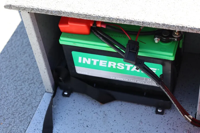 Slide: The Image of Battery compartment of 2025 Lund SSV-18 boat with Interstate battery installed. - 27