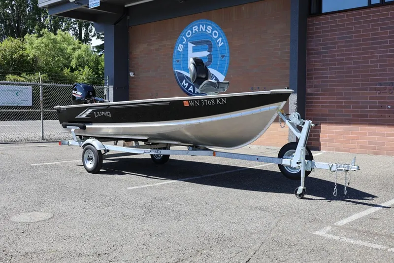 Slide: The Image of 2025 Lund SSV-18 boat on trailer, parked outside brick building. - 4