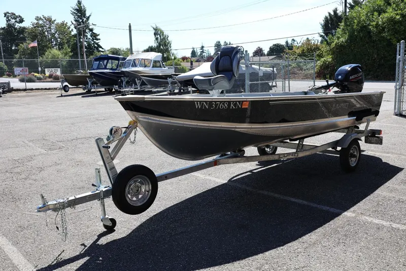 Slide: The Image of 2025 Lund SSV-18 boat on trailer in parking lot, side view. - 7