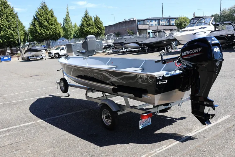 Slide: The Image of 2025 Lund SSV-18 boat with Mercury 40 engine on trailer in parking lot. - 9