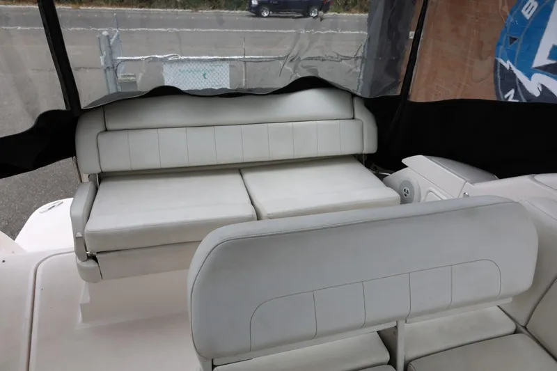 Slide: The Image of 2014 Regal 30 Express boat interior with white cushioned seating. - 11