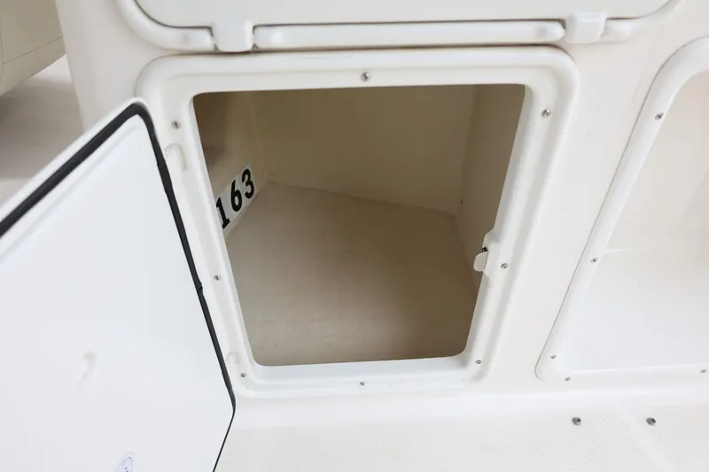 Slide: The Image of Open storage compartment on a 2014 Regal 30 Express boat. - 14