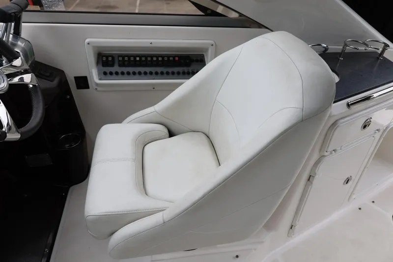 Slide: The Image of White captain's chair in 2014 Regal 30 Express boat cockpit. - 23