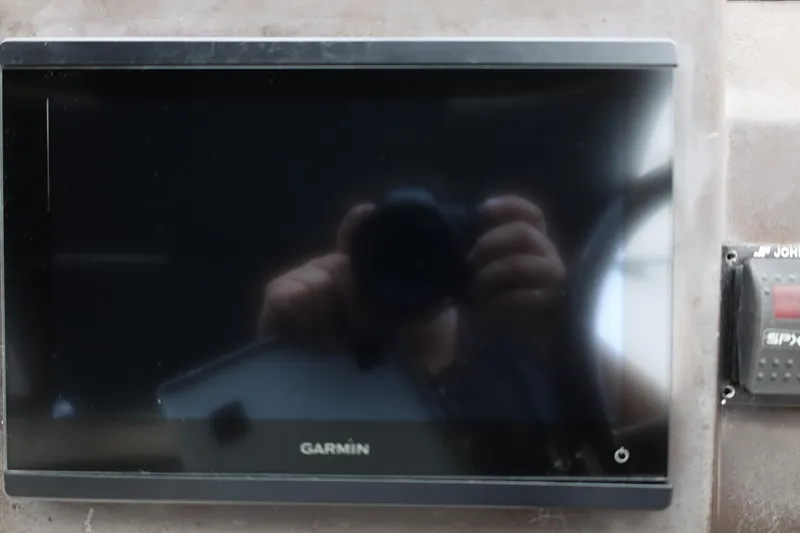 Slide: The Image of Garmin display on 2014 Regal 30 Express boat dashboard. - 24
