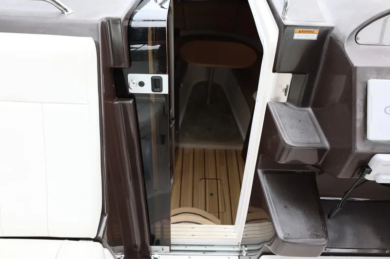 Slide: The Image of 2014 Regal 30 Express boat interior entrance with wooden flooring and seating. - 26