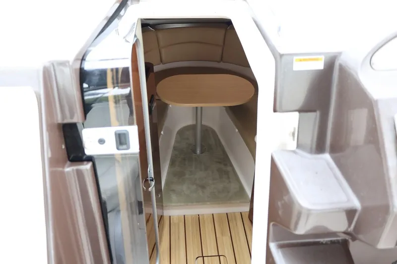 Slide: The Image of 2014 Regal 30 Express cabin interior with wooden table and seating area. - 27
