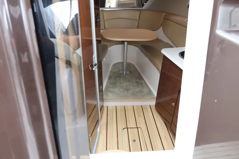 Slide: The Image of Interior of 2014 Regal 30 Express boat with seating and table. - 28