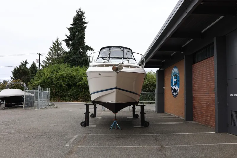 Slide: The Image of 2014 Regal 30 Express boat on stands outside a marina building. - 3