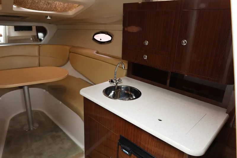 Slide: The Image of 2014 Regal 30 Express interior with kitchenette and seating area. - 30