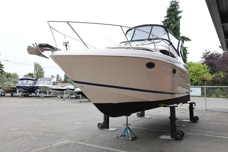Slide: The Image of 2014 Regal 30 Express boat on stands in a parking lot. - 4