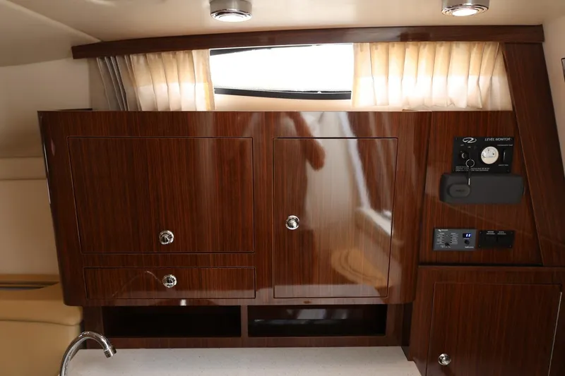 Slide: The Image of Interior of 2014 Regal 30 Express yacht with wooden cabinetry and control panel. - 42