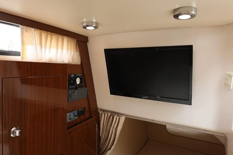 Slide: The Image of 2014 Regal 30 Express cabin interior with TV and wooden cabinetry. - 44