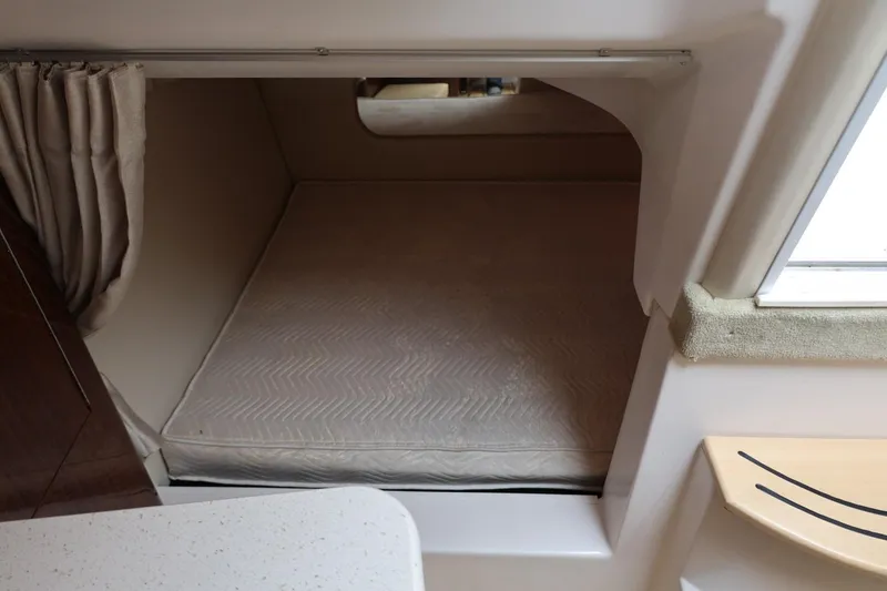 Slide: The Image of 2014 Regal 30 Express cabin interior with bed and window view. - 48