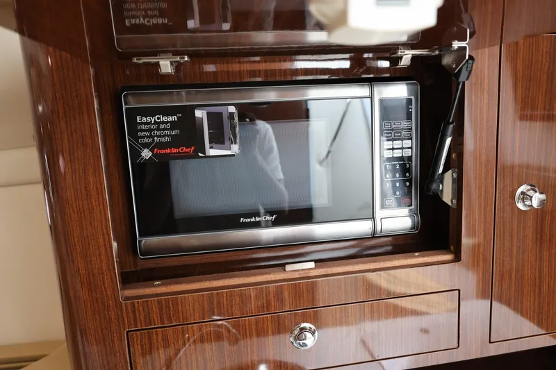 Slide: The Image of Microwave in 2014 Regal 30 Express boat with wood cabinetry. - 54
