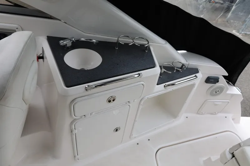 Slide: The Image of 2014 Regal 30 Express boat interior with sink and storage compartments. - 56