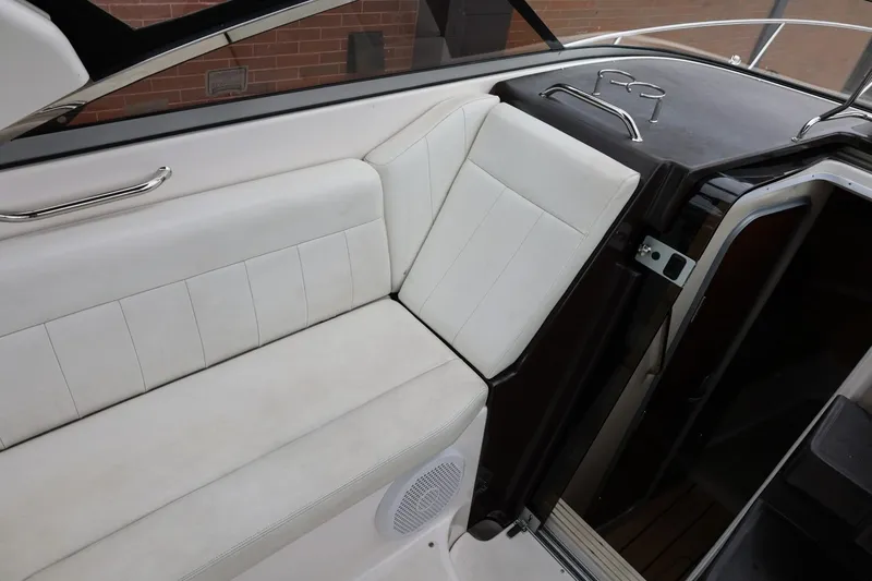 Slide: The Image of 2014 Regal 30 Express boat interior with white seating and cabin entrance. - 59