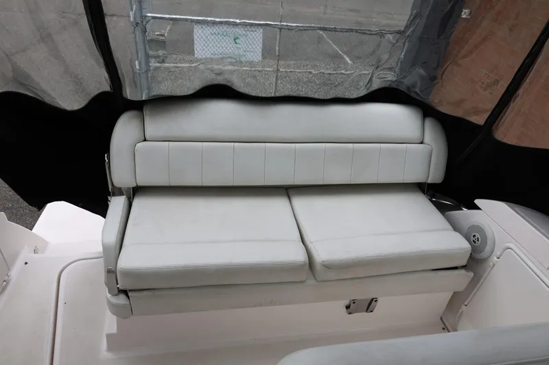 Slide: The Image of 2014 Regal 30 Express boat interior with white cushioned seating. - 61