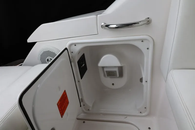 Slide: The Image of Open storage compartment on 2014 Regal 30 Express boat with speaker and handle. - 63
