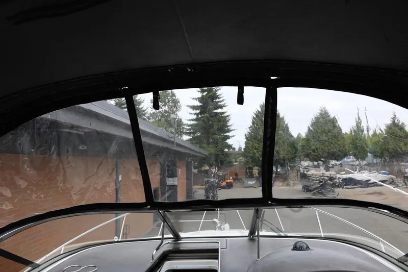 Slide: The Image of Interior view from a 2014 Regal 30 Express boat, showing the windshield and outdoor scenery. - 68