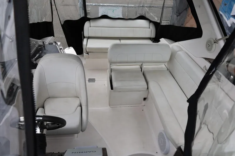 Slide: The Image of Interior of 2014 Regal 30 Express boat with white seating and steering area. - 74
