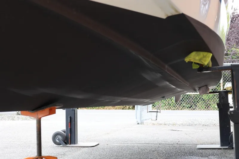 Slide: The Image of 2014 Regal 30 Express boat hull on stands, under maintenance. - 77