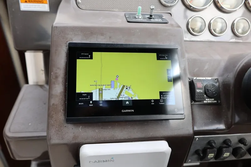 Slide: The Image of Garmin GPS system on 2014 Regal 30 Express boat dashboard, displaying navigation map. - 78