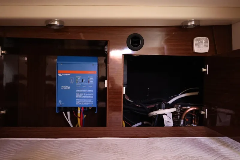 Slide: The Image of 2014 Regal 30 Express interior showing electrical panel and wiring compartments. - 95