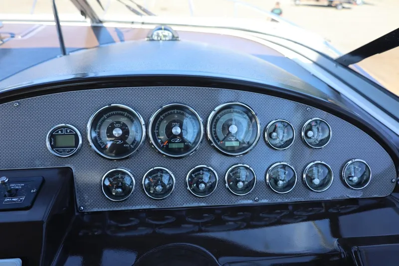Slide: The Image of Dashboard of a 2014 Regal 30 Express boat with multiple gauges and controls. - 97