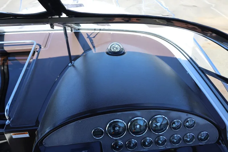 Slide: The Image of Dashboard of a 2014 Regal 30 Express boat with gauges and compass. - 98
