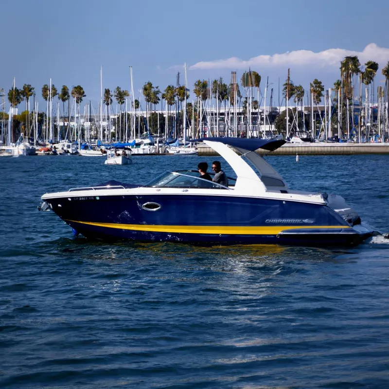 The Image of 2018 Chaparral 267 SSX boat cruising near marina with palm trees in background. - 0