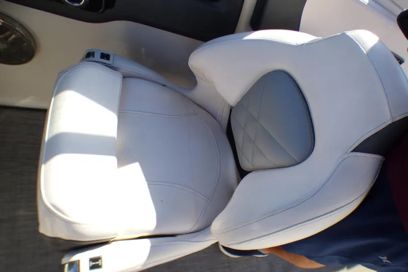 Slide: The Image of 2018 Chaparral 267 SSX boat seat, white and gray upholstery, close-up view. - 18