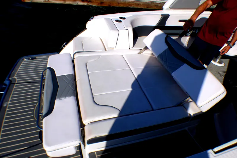 Slide: The Image of 2018 Chaparral 267 SSX boat interior with cushioned seating and deck. - 20