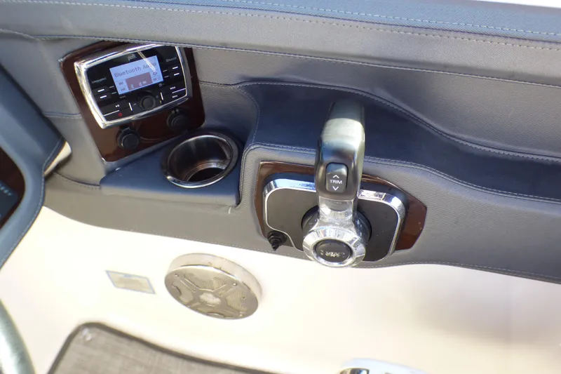 Slide: The Image of 2018 Chaparral 267 SSX boat dashboard with control panel and cup holder. - 22