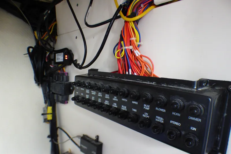 Slide: The Image of Electrical panel and wiring inside a 2018 Chaparral 267 SSX boat. - 24